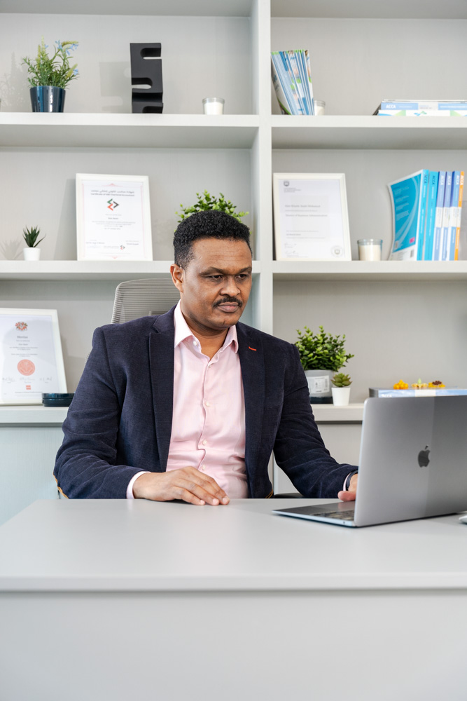 Elsir Badri working at his desk