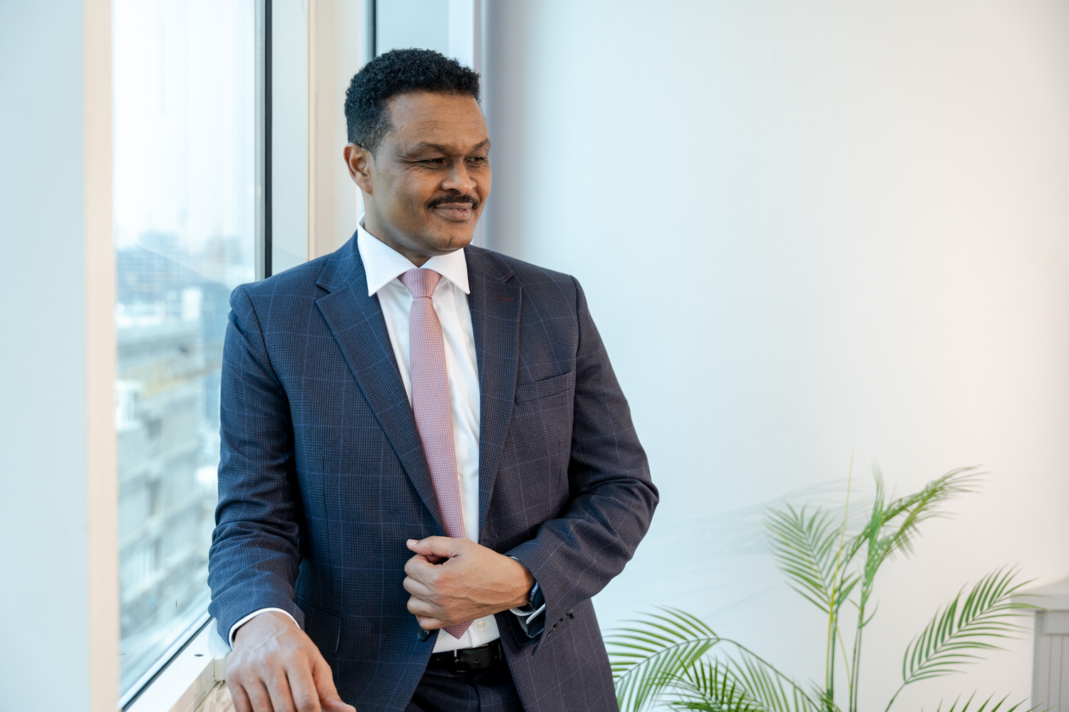 Elsir Badri standing by a window in his Dubai office